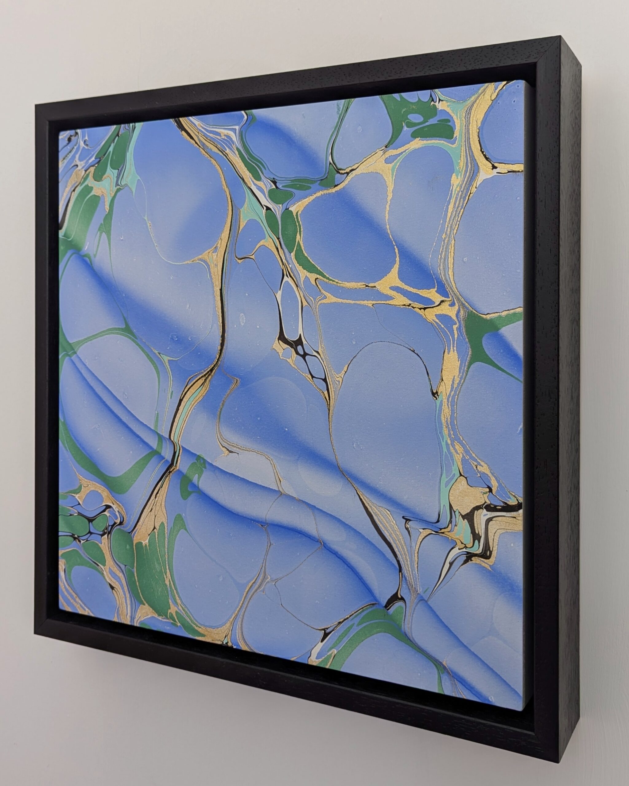 blue and green marbled artwork panel on a wall